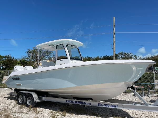 Everglades 285CC 2024 Everglades 285CC boat on trailer, clear sky background.