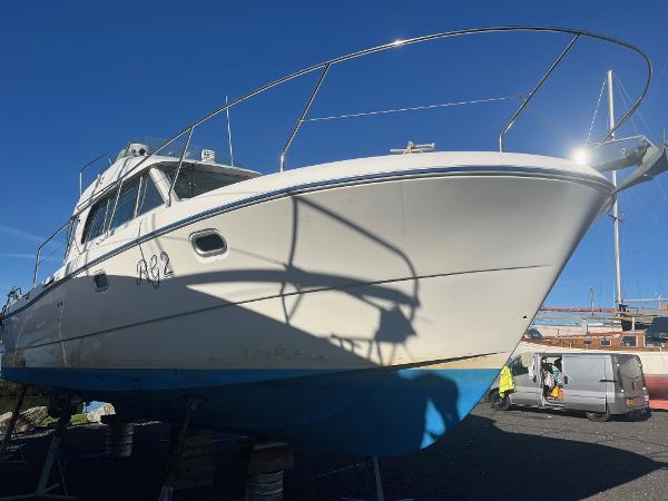 Beneteau Antares 10.80 2003 Beneteau Antares 10.80 boat on dry dock under clear blue sky.
