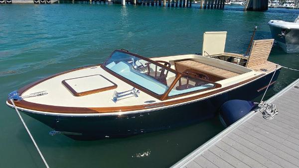 Bertram MOPPIE 1965 Bertram MOPPIE boat docked on clear blue water.