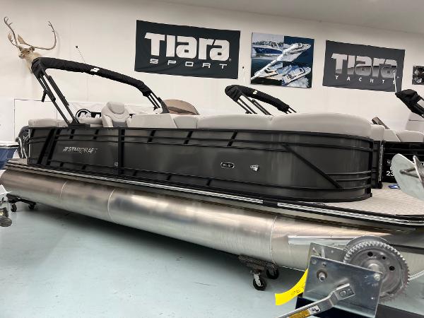 Starcraft SLS 5 Q DH 2024 Starcraft SLS 5 Q DH pontoon boat in showroom, sleek design, Tiara Sport banners.
