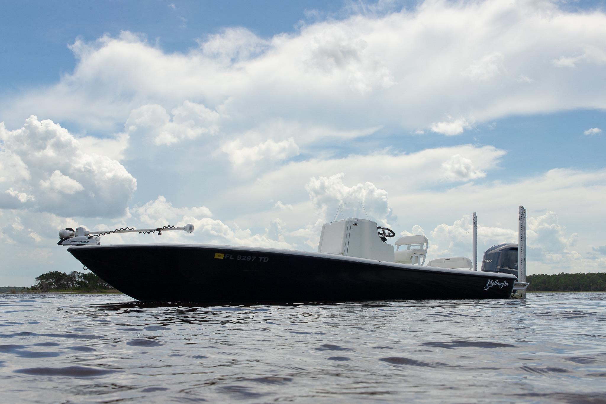 Yellowfin 24 Bay 2015 Yellowfin 24 Bay boat on calm water under a cloudy sky.