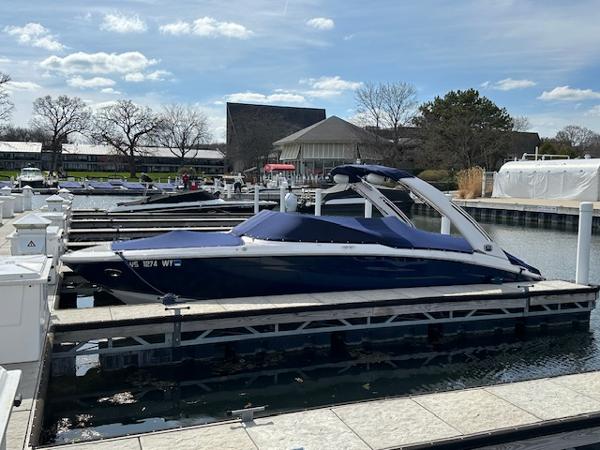 Regal LS6 Surf 2020 Regal LS6 Surf boat docked at a marina under a clear sky.