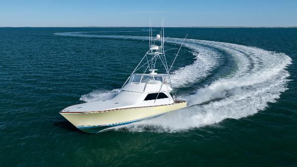 Viking 61 Convertible 2001 Viking 61 Convertible yacht cruising swiftly on open water.