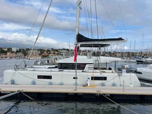 Lagoon 52 F 2019 Lagoon 52 F catamaran docked at marina with clear skies.
