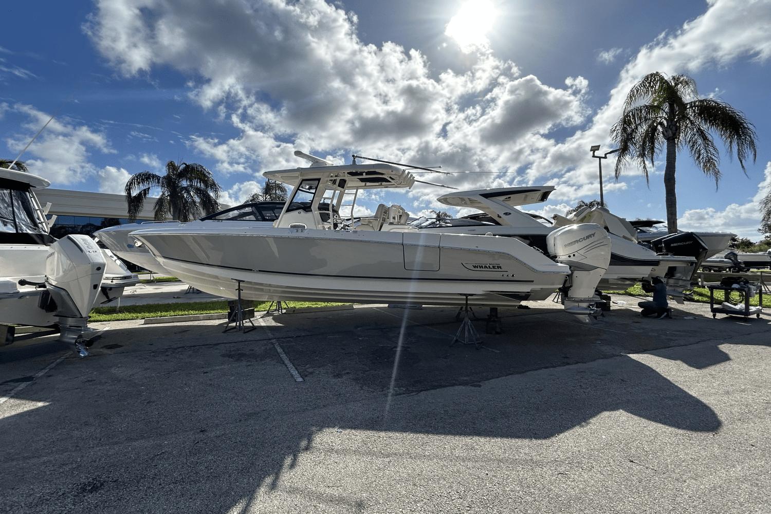 Boston Whaler 330 Outrage 2018 Boston Whaler 330 Outrage boat displayed outdoors under a sunny sky.