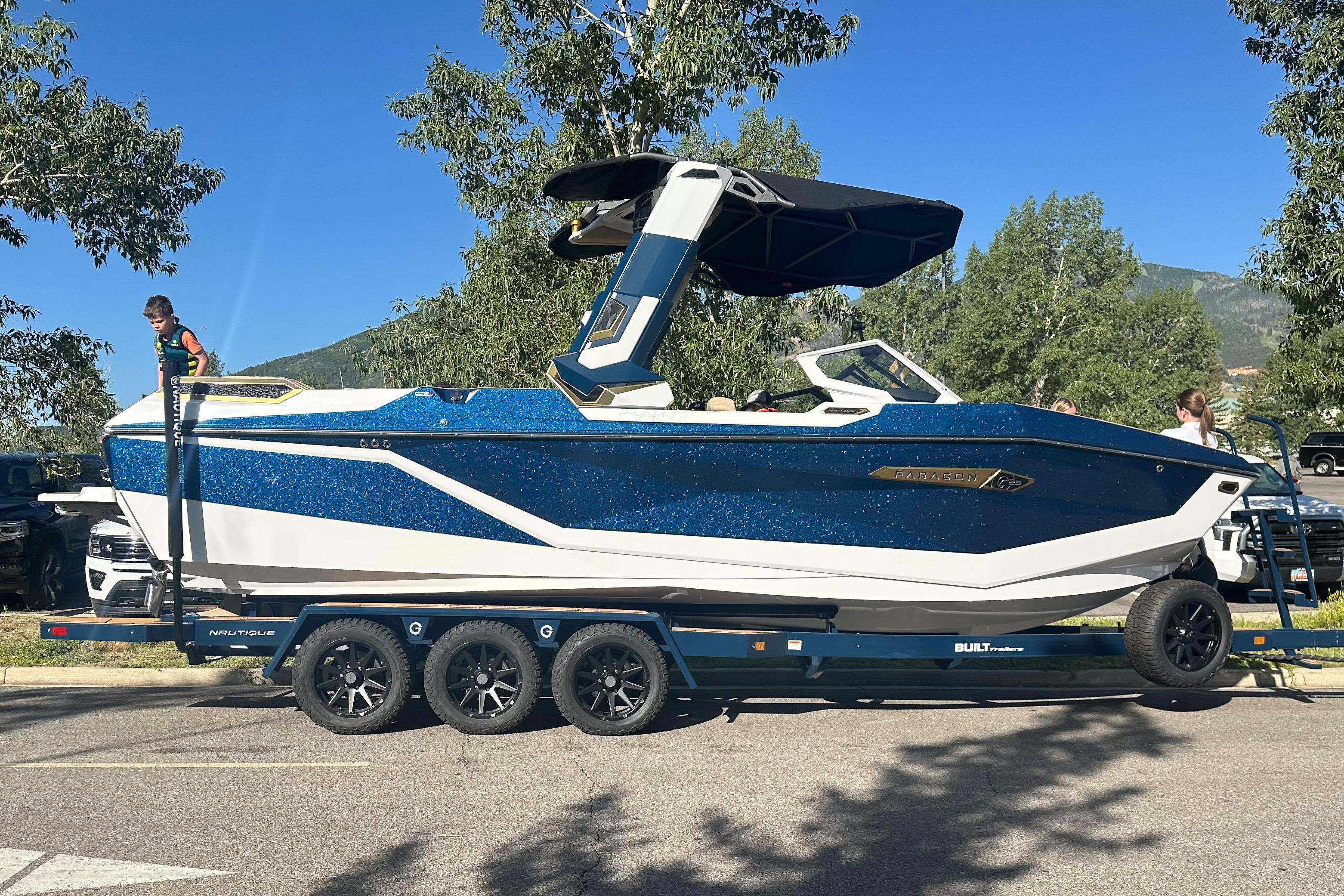 Nautique Super Air Nautique G25 Paragon 2025 Nautique Super Air Nautique G25 Paragon boat on trailer, parked outdoors.