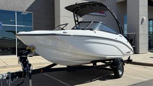 Yamaha Boats AR195 2025 Yamaha AR195 boat on trailer, displayed outdoors near a building.