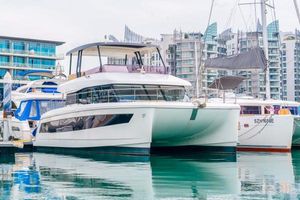 Fountaine Pajot MY6 2024 Fountaine Pajot MY6 yacht docked in a marina with modern buildings in the background.