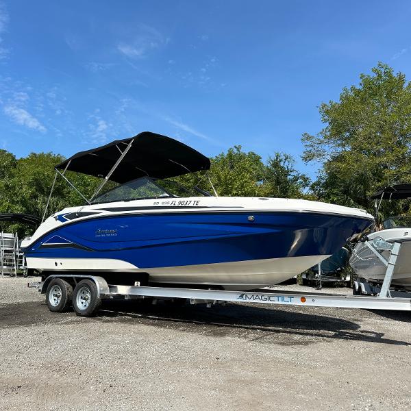 Hurricane SunDeck 235 OB 2022 Hurricane SunDeck 235 OB boat on trailer, blue and white design, parked outdoors.