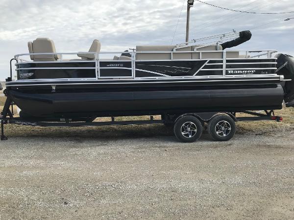 Ranger Reata 223FC 2025 Ranger Reata 223FC pontoon boat on trailer, side view, outdoors.
