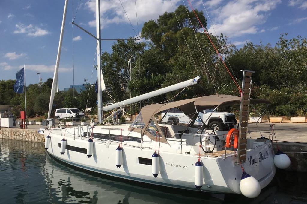 Jeanneau Sun Odyssey 490 2019 Jeanneau Sun Odyssey 490 sailboat docked at a marina under a clear sky.