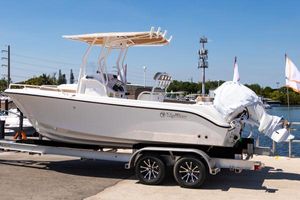 Edgewater 208CC 2025 Edgewater 208CC boat on trailer, dockside, under clear blue sky.