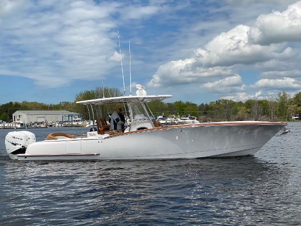 Mag Bay 33 Center Console 2025 Mag Bay 33 Center Console boat on water with clear sky background.