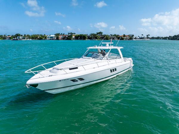 Intrepid 475 Sport Yacht 2018 Intrepid 475 Sport Yacht cruising on turquoise waters under a clear blue sky.