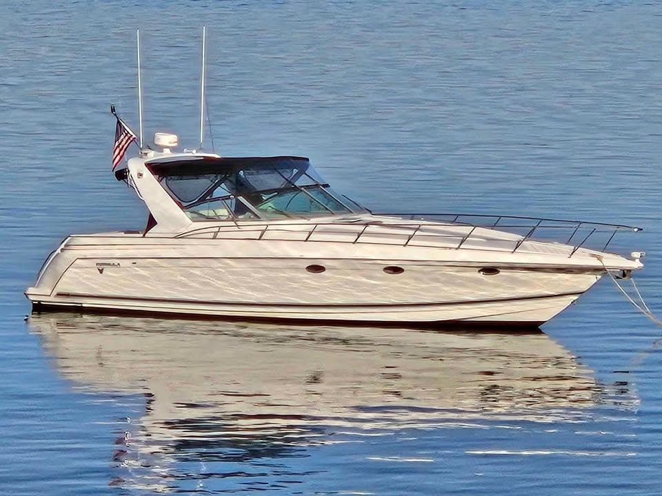 Formula 41 PC 1998 Formula 41 PC yacht on calm water with American flag.