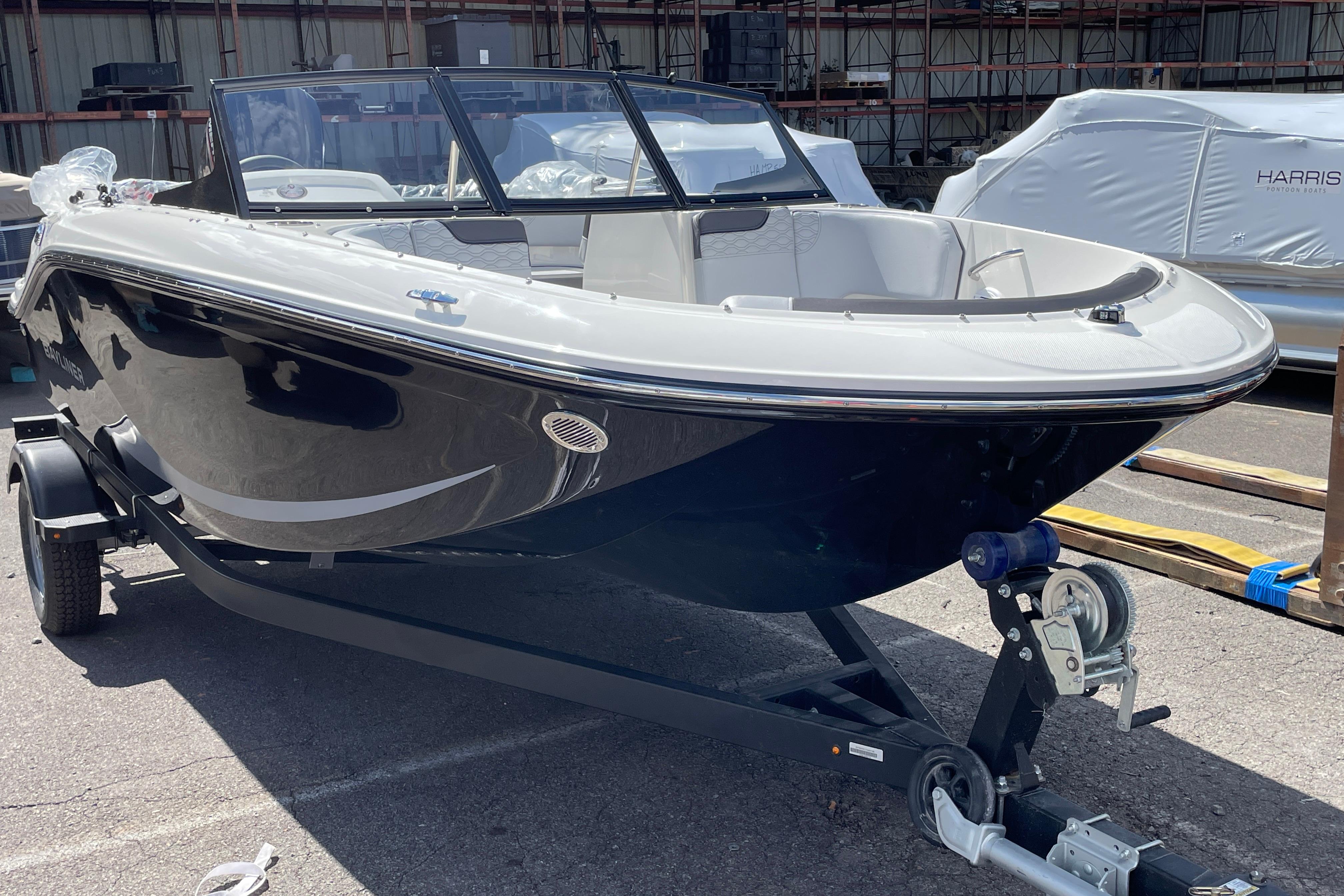 Bayliner Element E17 2026 Bayliner Element E17 boat on trailer in outdoor storage area.
