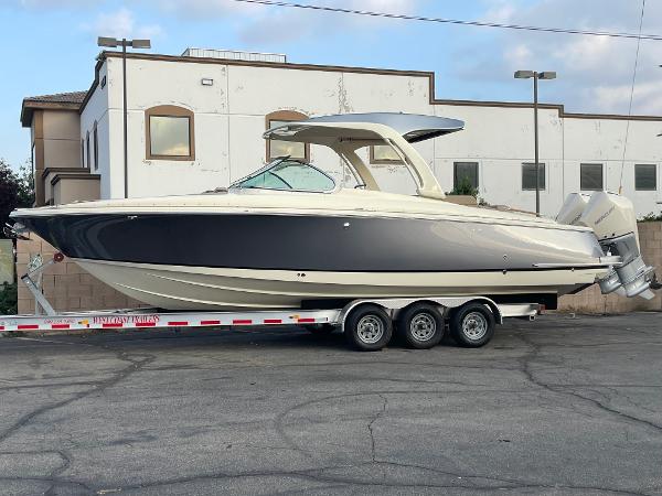Chris-Craft Launch 31 GT 2024 Chris-Craft Launch 31 GT boat on trailer, parked outdoors.