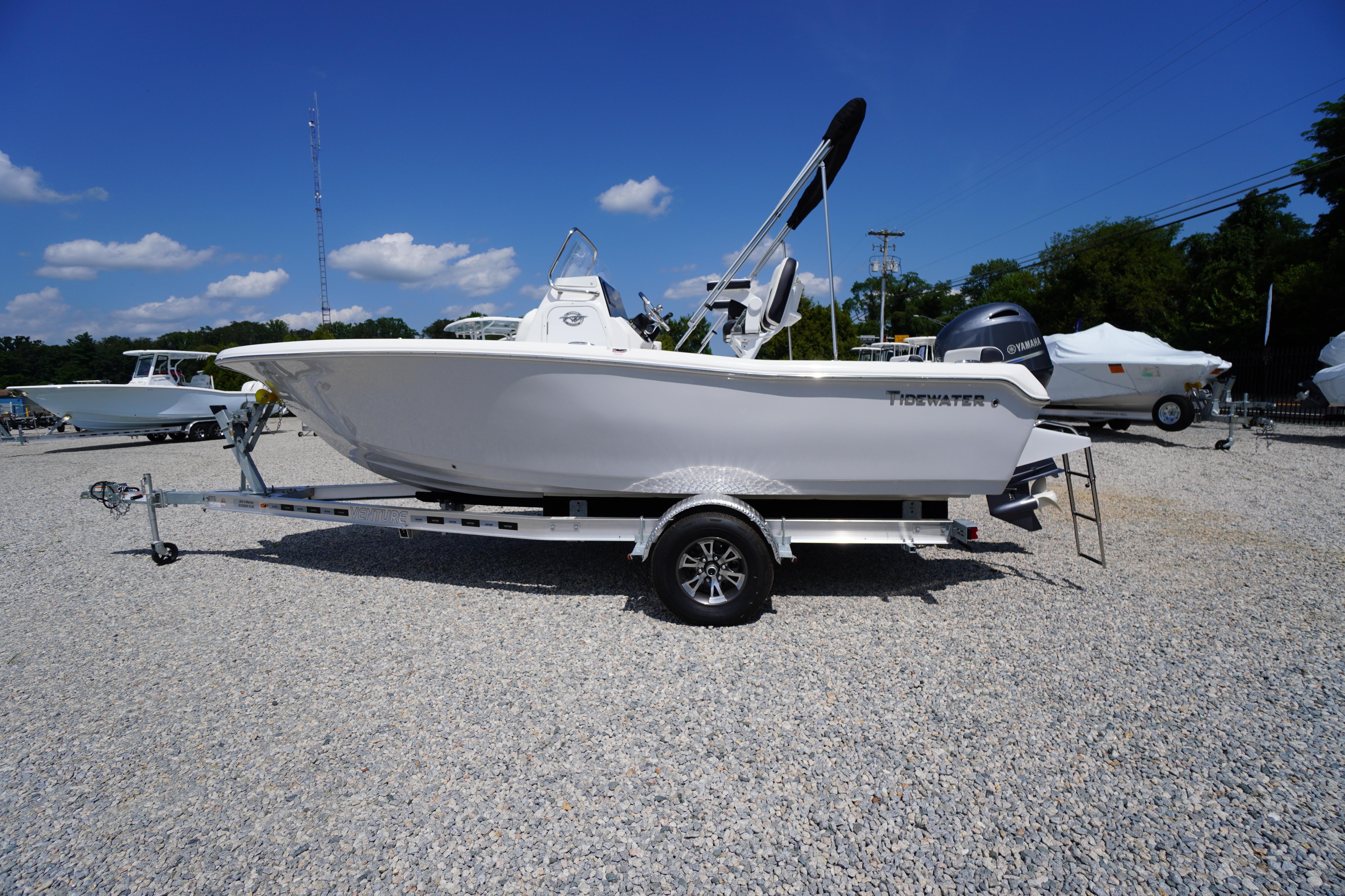Tidewater 198 CC Adventure 2025 Tidewater 198 CC Adventure boat on trailer, displayed outdoors under blue sky.