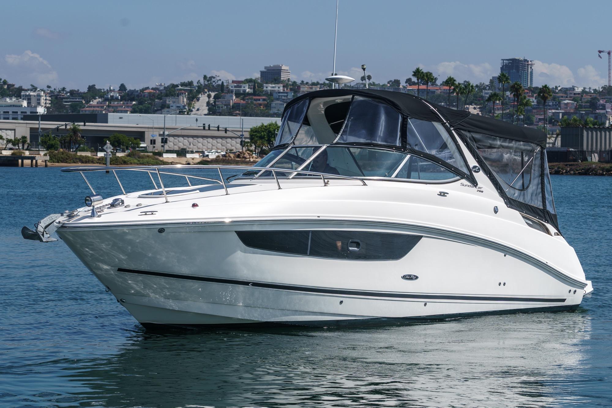 Sea Ray 280 Sundancer 2016 Sea Ray 280 Sundancer boat on calm water, cityscape background.