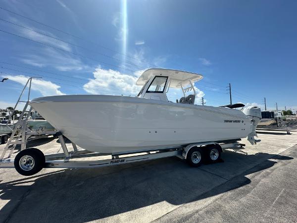 Twin Vee 260 GFX2 CC 2025 Twin Vee 260 GFX2 CC boat on trailer under sunny sky.