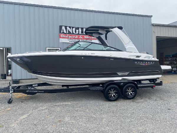 Monterey 258 Super Sport 2025 Monterey 258 Super Sport boat on trailer outside a marine dealership.