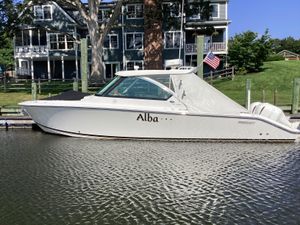 Pursuit DC 325 Dual Console 2017 Pursuit DC 325 Dual Console boat docked by waterfront homes.