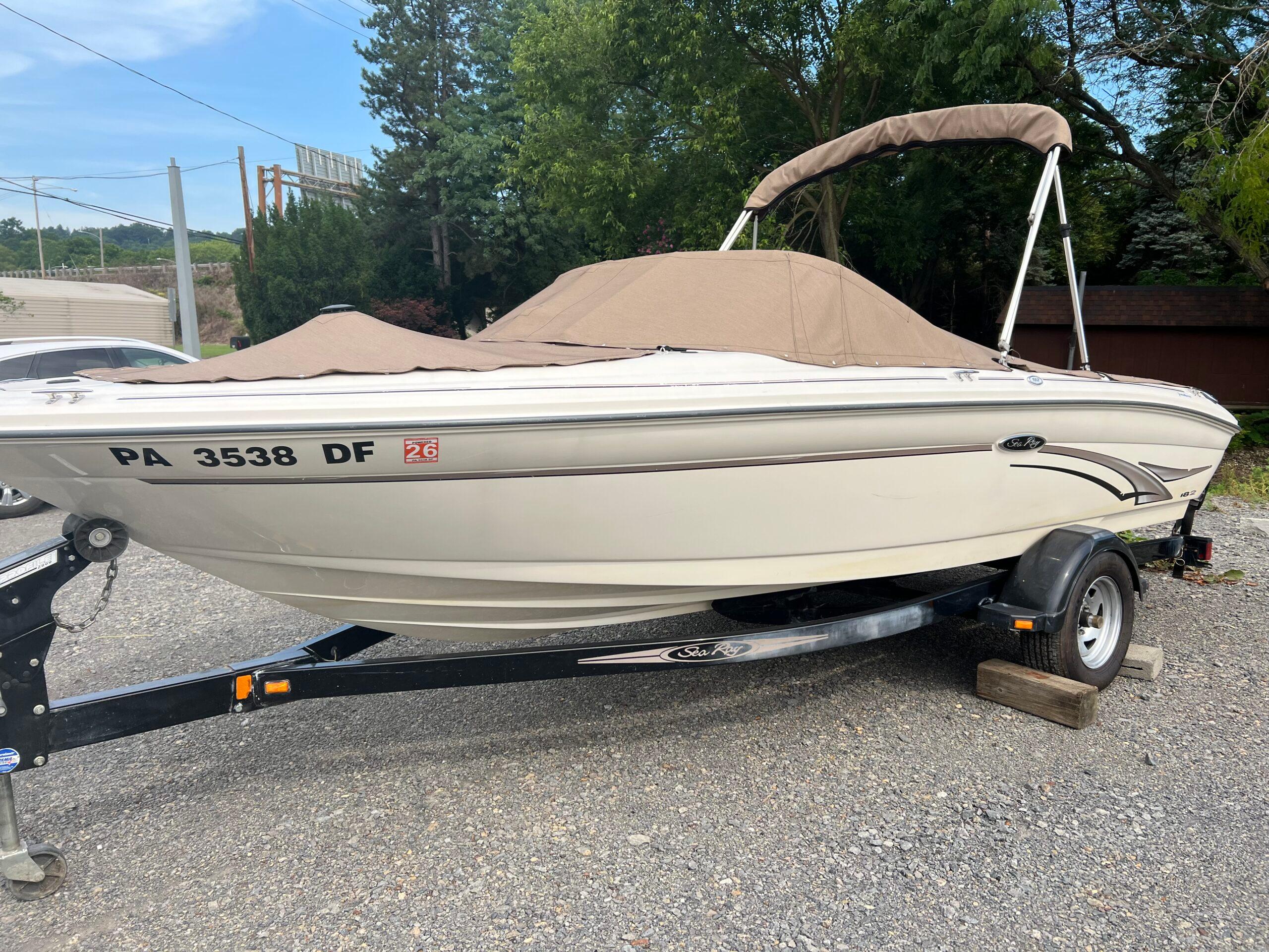 Sea Ray 182 Bow Rider 2002 Sea Ray 182 Bow Rider boat on trailer, covered, parked outdoors.