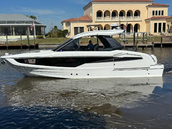 Galeon 325 GTO 2022 Galeon 325 GTO luxury yacht docked near waterfront homes.