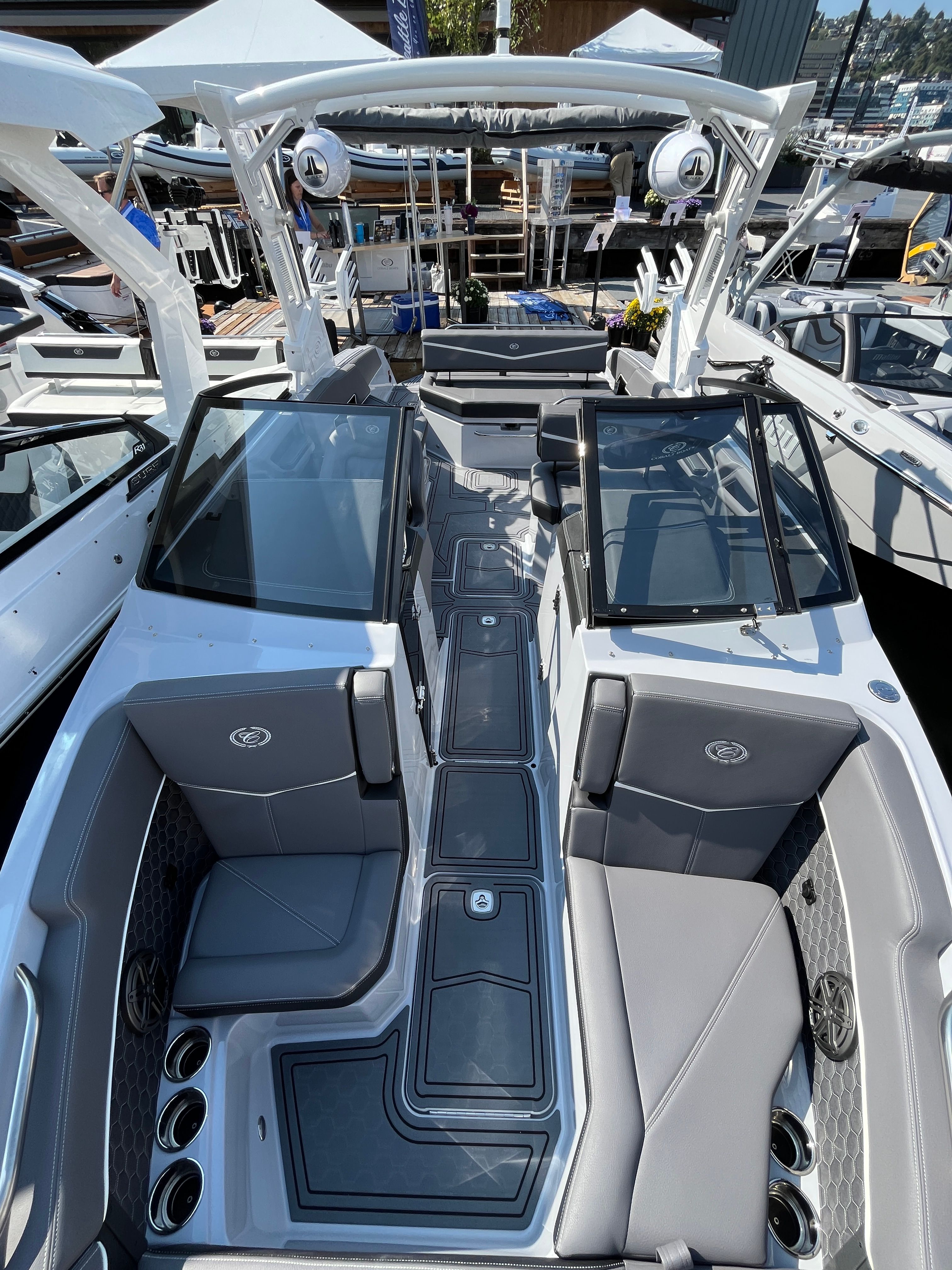 Cobalt R6 Surf 2026 Cobalt R6 Surf boat interior with sleek seating and modern design at a marina.