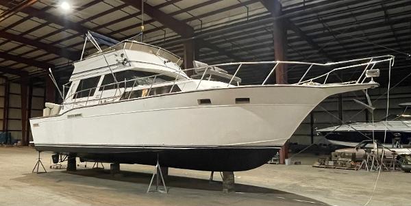 Marinette 41 Marquis Convertible 1989 Marinette 41 Marquis Convertible boat in indoor storage facility.