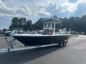 Sea Pro 248 Bay Series 2022 Sea Pro 248 Bay Series boat on trailer under cloudy sky.