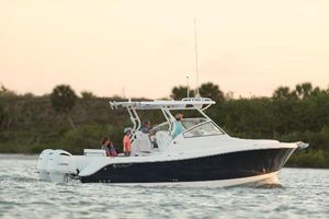 Edgewater 280CX Crossover 2025 Edgewater 280 CX boat cruising on calm water at sunset.