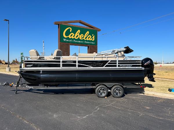 Ranger Reata 223FC 2024 Ranger Reata 223FC pontoon boat displayed outside Cabela's store.