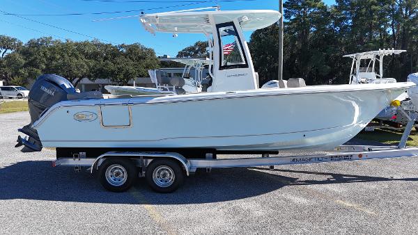 Sea Hunt Ultra 235 SE 2025 Sea Hunt Ultra 235 SE boat on trailer, side view, outdoors.