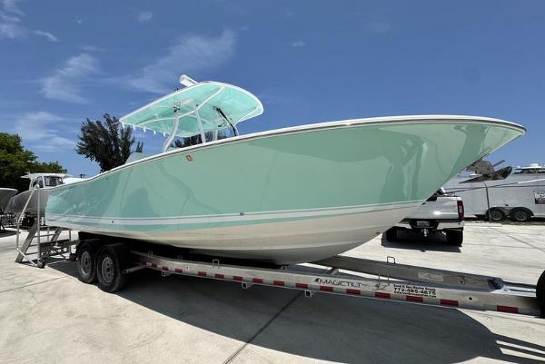 Southport 29 FE 2015 Southport 29 FE boat on trailer, light blue hull, sunny day.