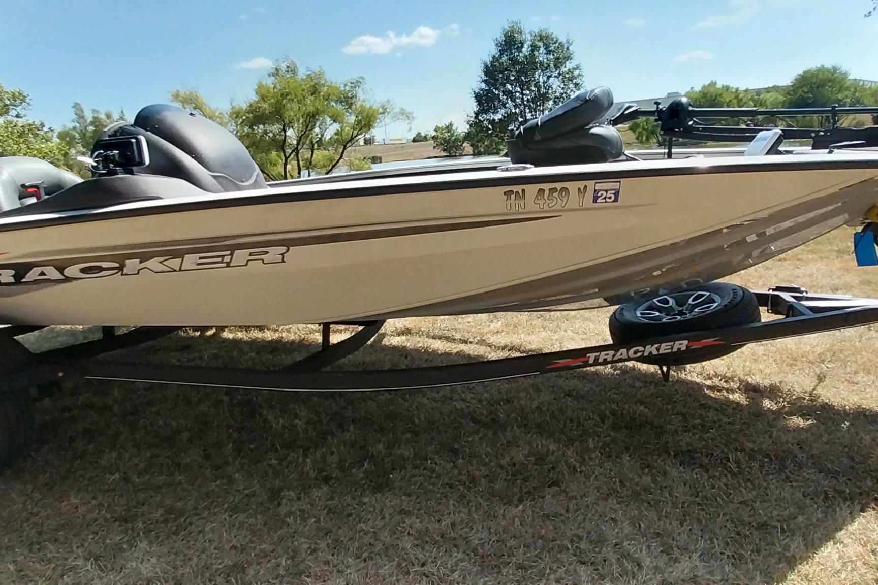 Tracker Pro Team 195 TXW Tournament Edition 2023 Tracker Pro Team 195 TXW Tournament Edition boat on trailer, parked on grass.