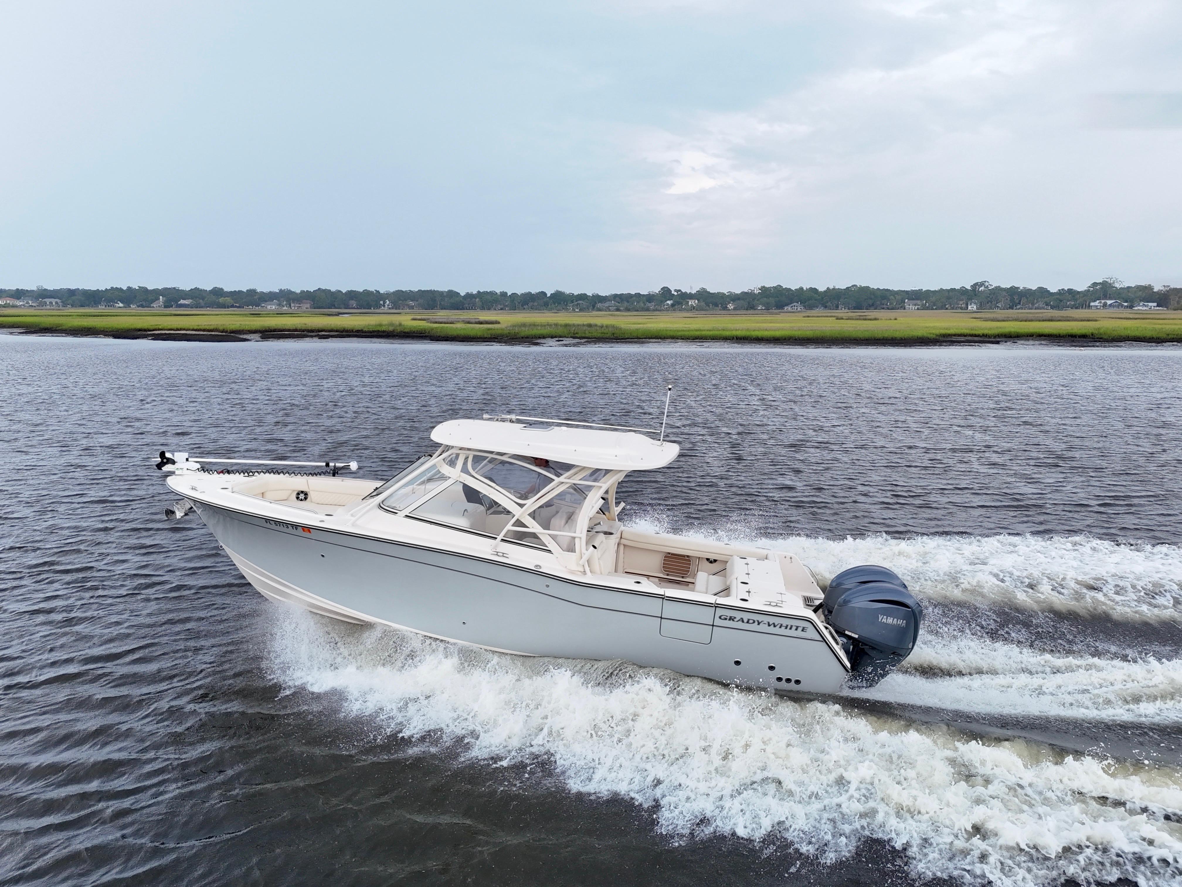 Grady-White Freedom 307 2022 Grady-White Freedom 307 boat cruising on a calm river.