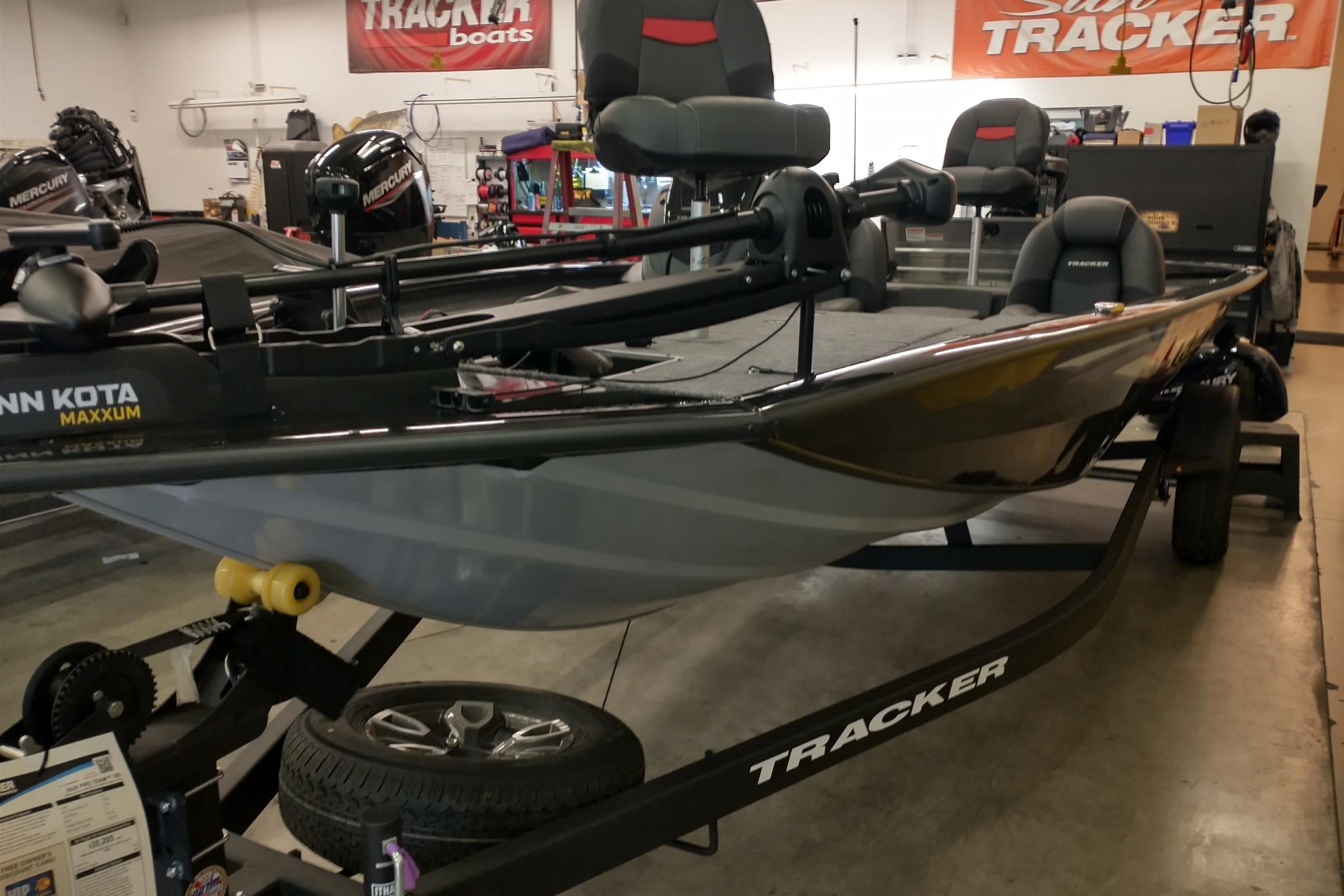 Tracker Pro Team 195 2026 Tracker Pro Team 195 boat in showroom, featuring Minn Kota Maxxum motor.