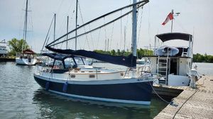 Hinterhoeller Nonsuch 1982 Hinterhoeller Nonsuch sailboat docked at a marina with other boats.