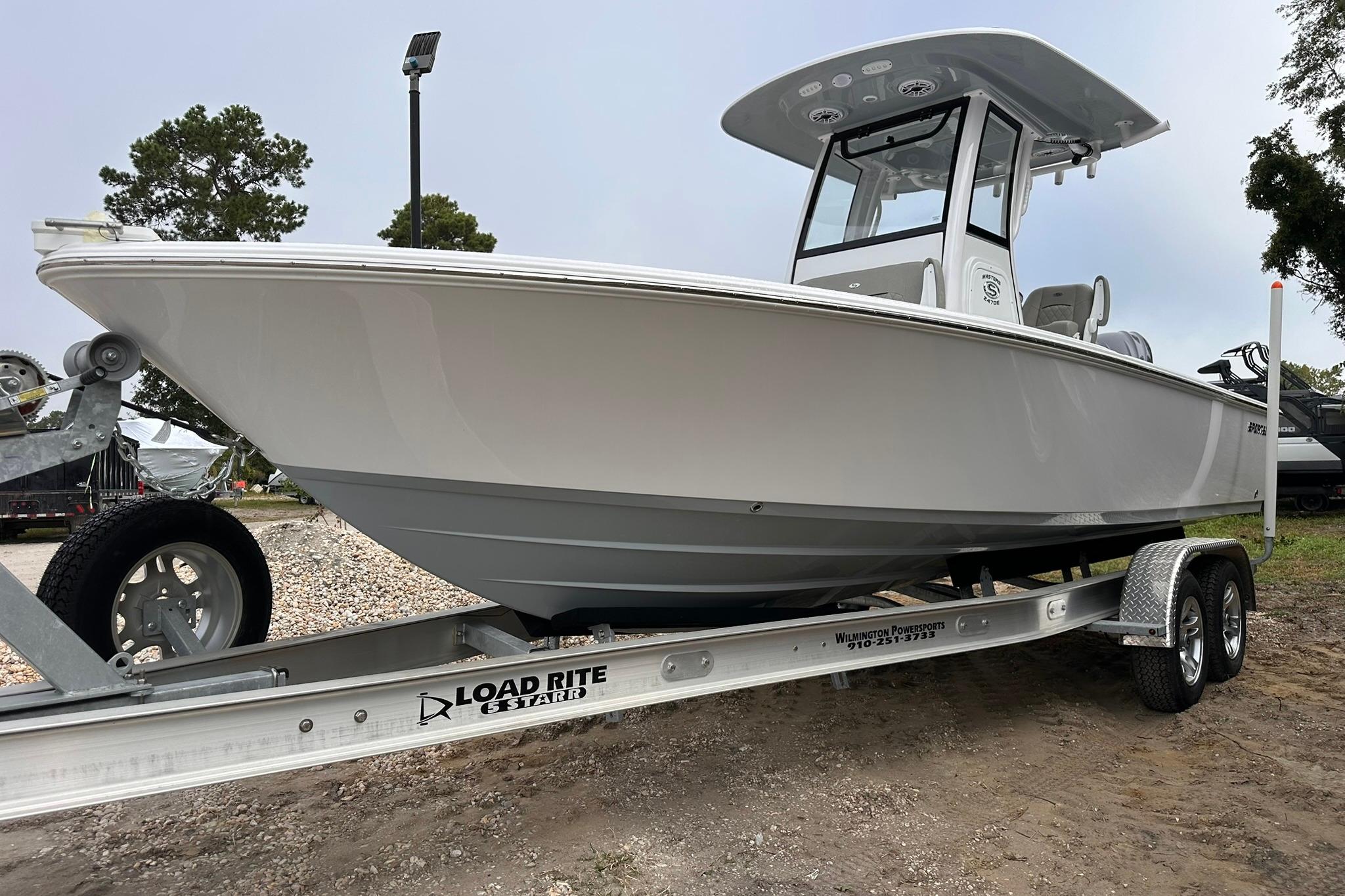Sportsman Masters 247OE Bay Boat 2025 Sportsman Masters 247OE Bay Boat on trailer, side view.