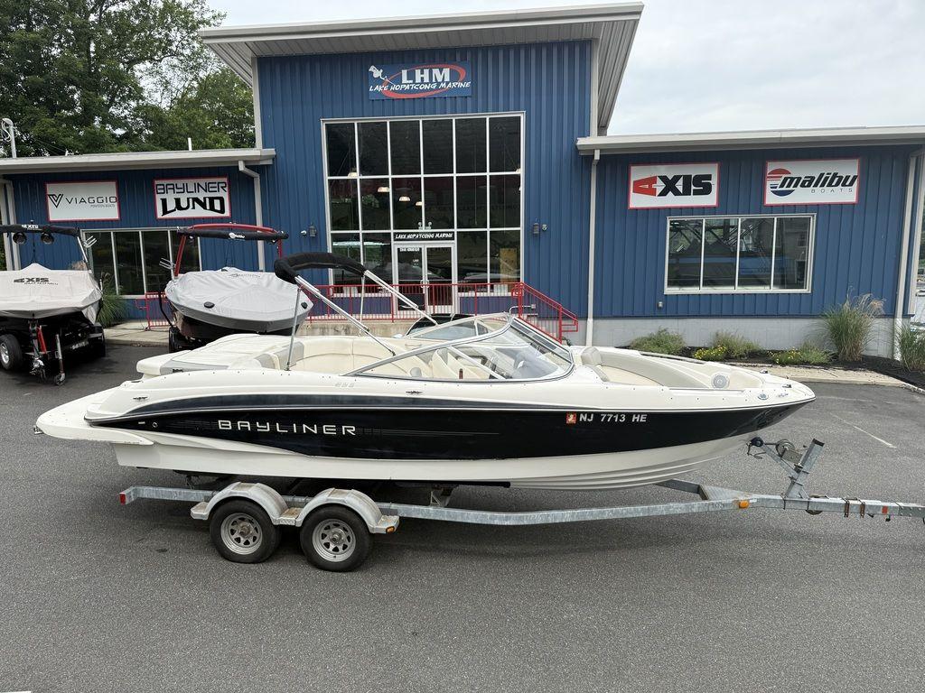 Bayliner 235 BR 2012 Bayliner 235 BR boat on trailer outside dealership.