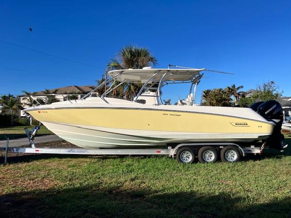 Boston Whaler 320 Outrage Cuddy Cabin 2016 Boston Whaler 320 Outrage Cuddy Cabin on trailer, parked on grass.