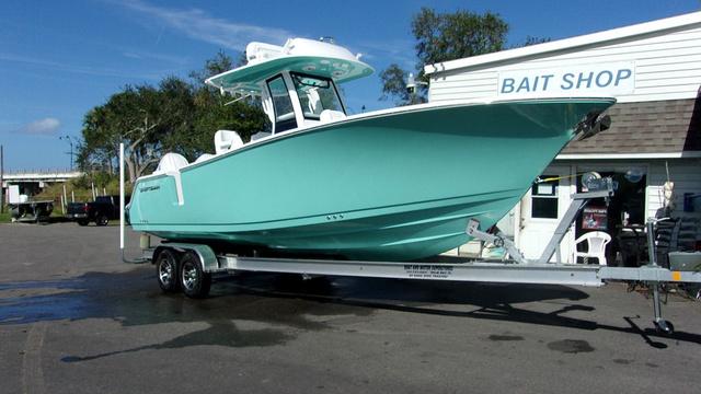 Sportsman Heritage 261 2025 Sportsman Heritage 261 boat on trailer outside bait shop.