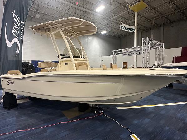 Scout 195 Sportfish 2024 Scout 195 Sportfish boat displayed indoors at a showroom.