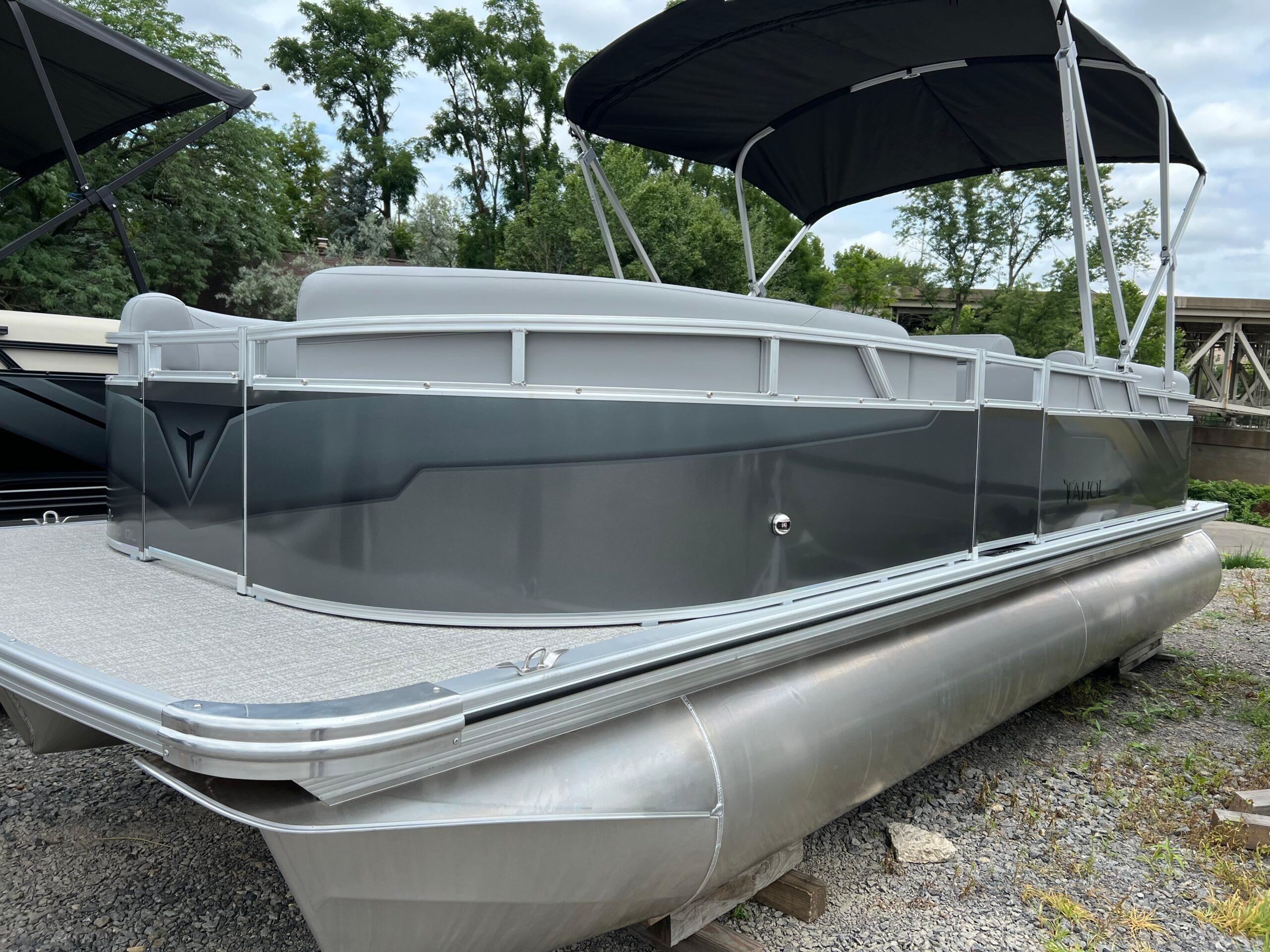 Tahoe Pontoon 2180 2026 Tahoe Pontoon 2180 boat with sleek design and canopy, parked on gravel.