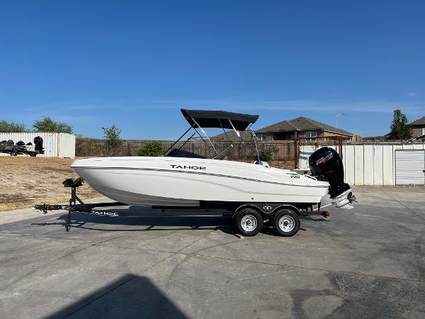 Tahoe T21 2024 Tahoe T21 boat on trailer in driveway, ready for transport.