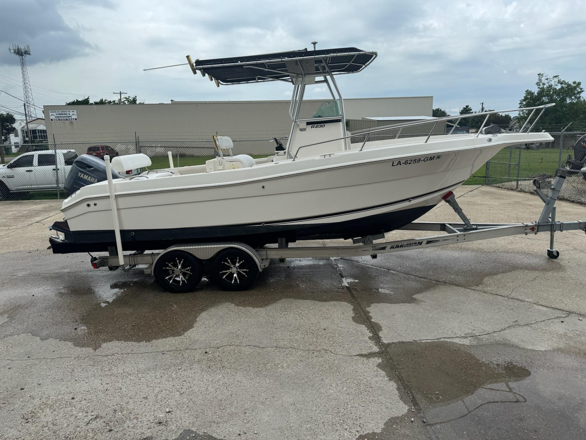 Robalo R230 Center Console 2004 Robalo R230 Center Console boat on trailer, parked outdoors.