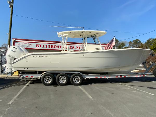 Cobia 320 Center Console 2025 Cobia 320 Center Console boat on trailer in parking lot.