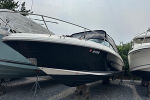 Sea Ray 290 SLX 2005 Sea Ray 290 SLX boat on stands, black hull, parked outdoors.