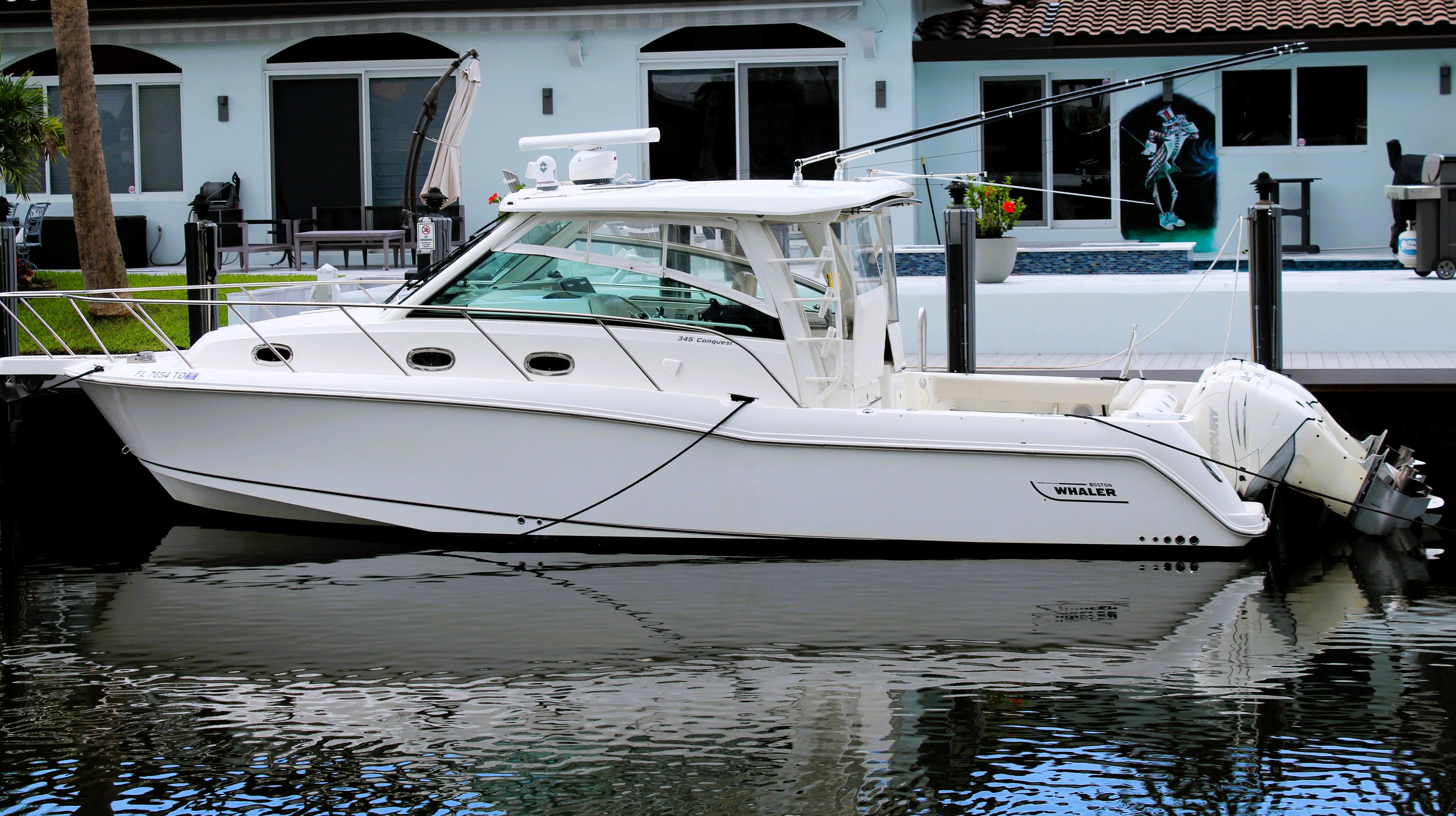 Boston Whaler 345 Conquest 2017 Boston Whaler 345 Conquest boat docked by waterfront home.